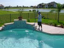 Brushing pool walls